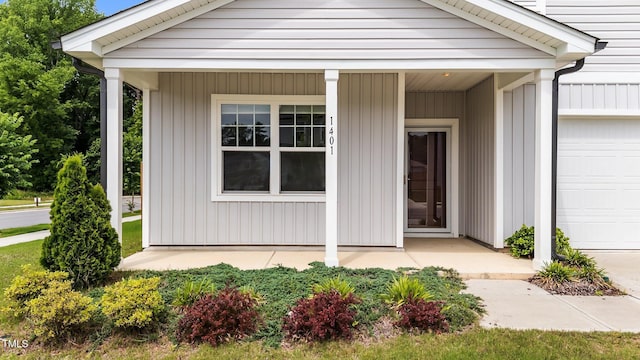 1401 Justice Union Ct, Raleigh, NC 27604 - doorway to property featuring an attached garage and covered porch