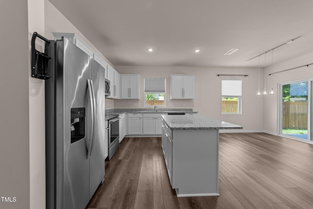 1401 Justice Union Ct, Raleigh, NC 27604 - kitchen with stainless steel appliances, a kitchen island, dark wood-type flooring, white cabinetry, and rail lighting