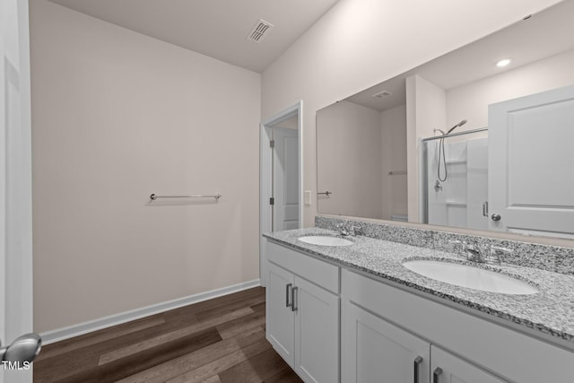1401 Justice Union Ct, Raleigh, NC 27604 - bathroom with double vanity, wood finished floors, baseboards, and a shower