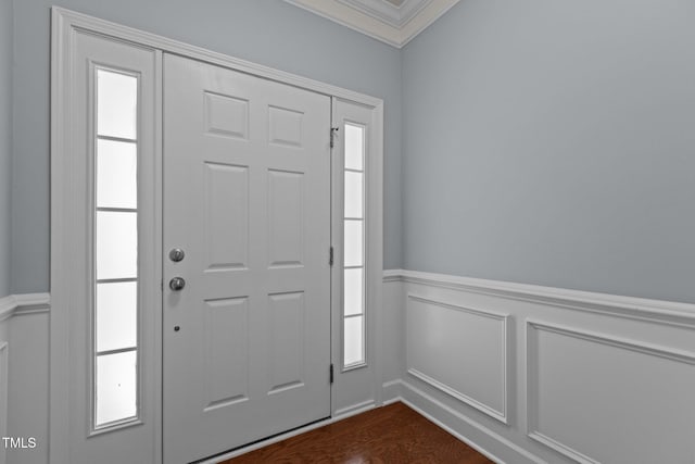2082 Weston Green Loop, Cary, NC 27513 - foyer entrance featuring ornamental molding, wainscoting, a decorative wall, and dark wood-type flooring