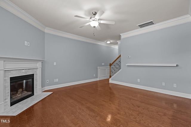2082 Weston Green Loop, Cary, NC 27513 - unfurnished living room with ornamental molding, a ceiling fan, a fireplace with flush hearth, stairway, and wood finished floors