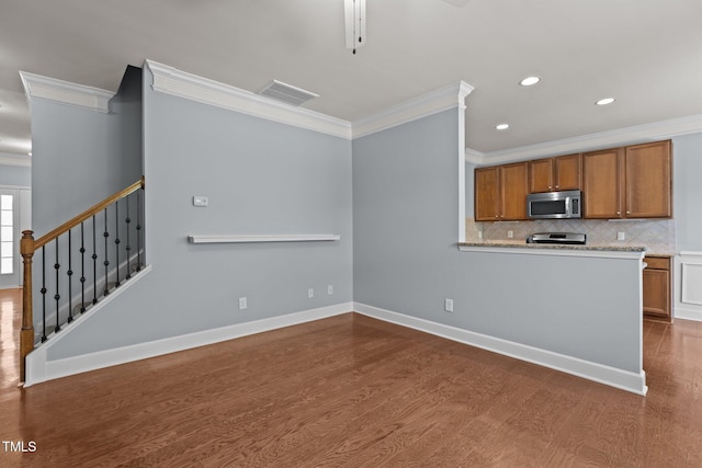 2082 Weston Green Loop, Cary, NC 27513 - kitchen with appliances with stainless steel finishes, ornamental molding, dark wood finished floors, brown cabinetry, and decorative backsplash