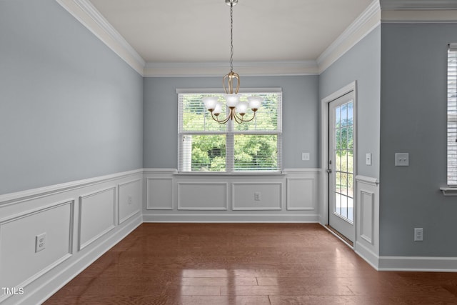 2082 Weston Green Loop, Cary, NC 27513 - unfurnished dining area featuring a chandelier, wainscoting, crown molding, and dark wood-style floors