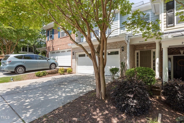2082 Weston Green Loop, Cary, NC 27513 - view of front of house featuring an attached garage, brick siding, and concrete driveway