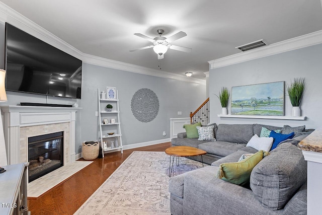 2082 Weston Green Loop, Cary, NC 27513 - living area featuring crown molding, a ceiling fan, a premium fireplace, stairs, and dark wood-style flooring