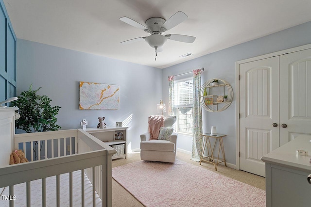 2082 Weston Green Loop, Cary, NC 27513 - bedroom featuring light carpet, a nursery area, a closet, baseboards, and ceiling fan