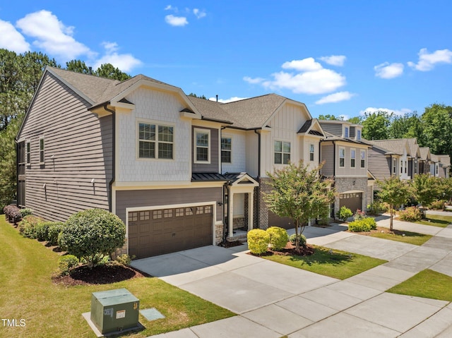 1896 Blue Jay Pt, Apex, NC 27502 - townhome / multi-family property with an attached garage, driveway, a front lawn, stone siding, and a shingled roof