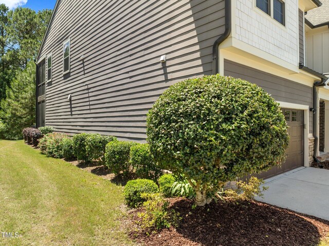 1896 Blue Jay Pt, Apex, NC 27502 - view of property exterior featuring an attached garage, a lawn, and concrete driveway