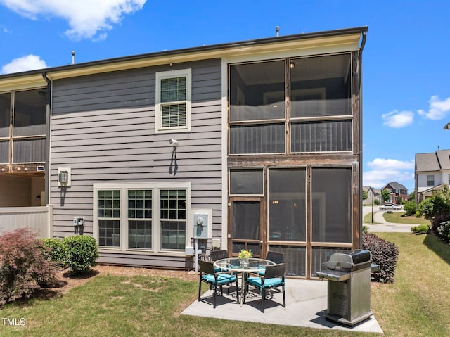 1896 Blue Jay Pt, Apex, NC 27502 - back of house featuring a patio area, a yard, and a sunroom