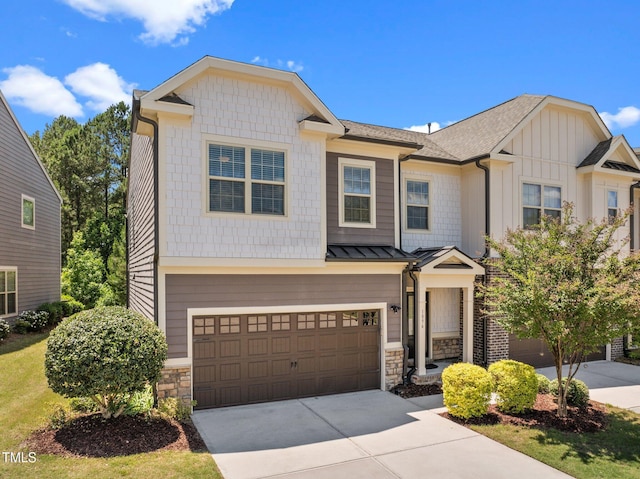 1896 Blue Jay Pt, Apex, NC 27502 - view of front of property featuring concrete driveway, stone siding, a standing seam roof, an attached garage, and board and batten siding