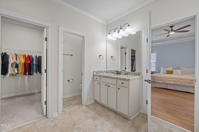 1896 Blue Jay Pt, Apex, NC 27502 - ensuite bathroom with vanity, a spacious closet, crown molding, a ceiling fan, and toilet