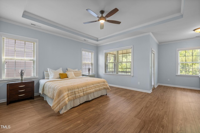 1896 Blue Jay Pt, Apex, NC 27502 - bedroom with a raised ceiling, wood finished floors, baseboards, and ornamental molding