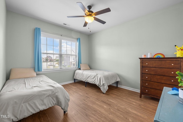 1896 Blue Jay Pt, Apex, NC 27502 - bedroom with baseboards, wood finished floors, and ceiling fan