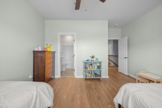 1896 Blue Jay Pt, Apex, NC 27502 - bedroom with wood finished floors, baseboards, ensuite bath, and a ceiling fan