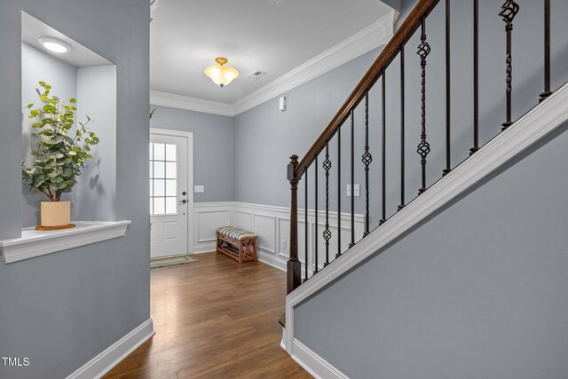1896 Blue Jay Pt, Apex, NC 27502 - foyer entrance featuring stairway, wood finished floors, ornamental molding, and wainscoting