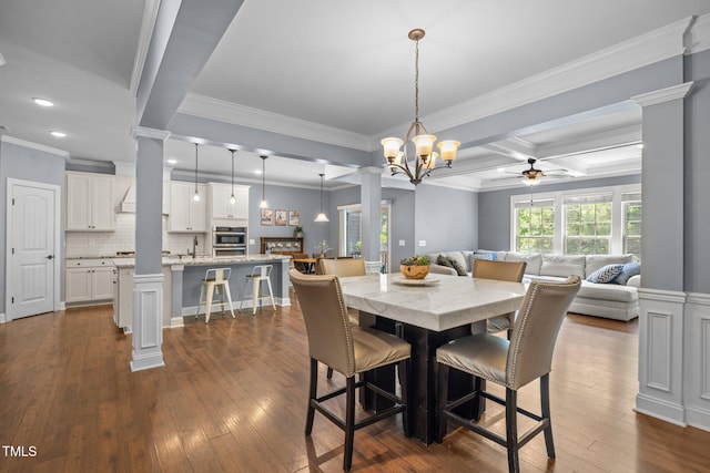 1896 Blue Jay Pt, Apex, NC 27502 - dining area featuring decorative columns, a ceiling fan, dark wood-style flooring, ornamental molding, and beamed ceiling