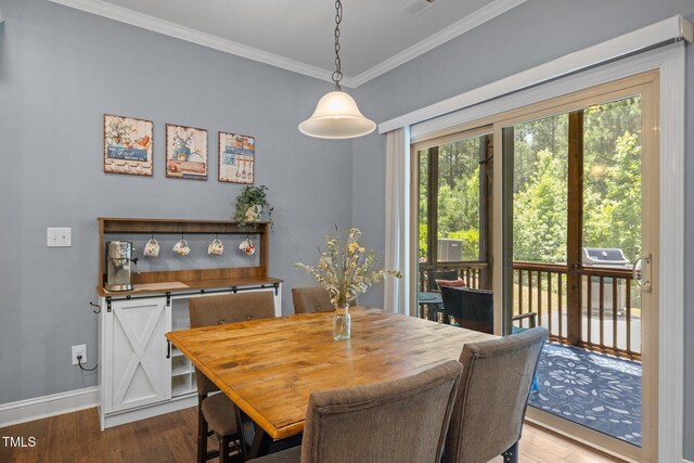 1896 Blue Jay Pt, Apex, NC 27502 - dining room with crown molding, dark wood-type flooring, and baseboards