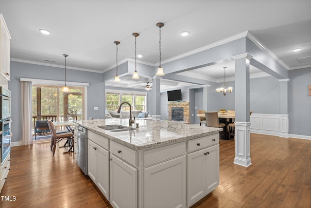 1896 Blue Jay Pt, Apex, NC 27502 - kitchen with a sink, a fireplace, ornate columns, ceiling fan, and dishwasher