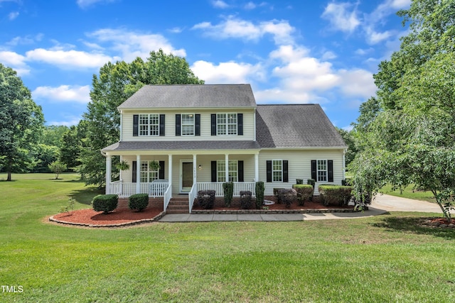 113 Feezor Ct, Clayton, NC 27527 - colonial inspired home with covered porch, a front lawn, and roof with shingles