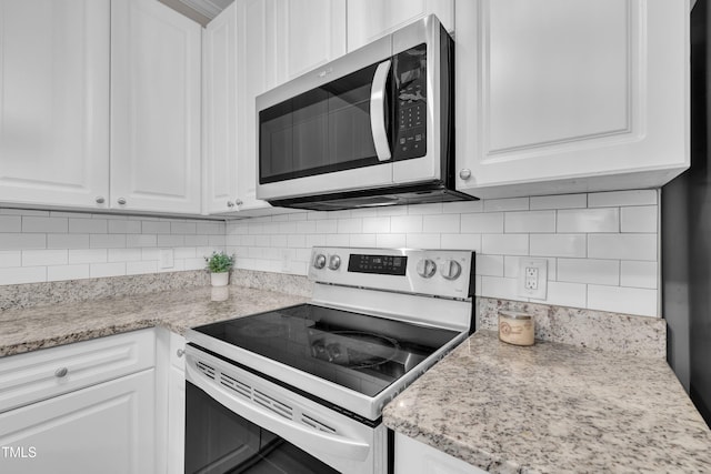 113 Feezor Ct, Clayton, NC 27527 - kitchen with range with electric stovetop, stainless steel microwave, and white cabinetry