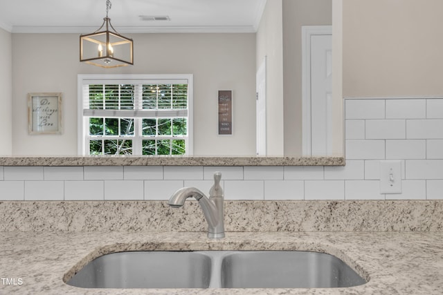 113 Feezor Ct, Clayton, NC 27527 - kitchen view of backsplash, ornamental molding, light stone countertops, decorative light fixtures, and a chandelier