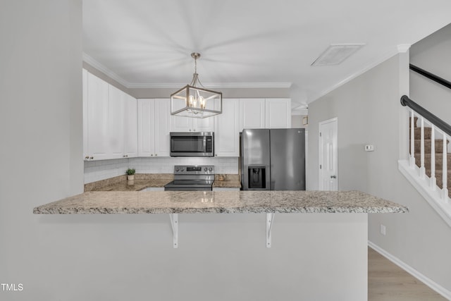 113 Feezor Ct, Clayton, NC 27527 - kitchen featuring appliances with stainless steel finishes, a peninsula, decorative backsplash, white cabinetry, and crown molding