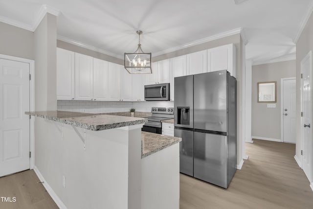 113 Feezor Ct, Clayton, NC 27527 - kitchen with stainless steel appliances, a peninsula, a chandelier, light wood-style floors, and white cabinets