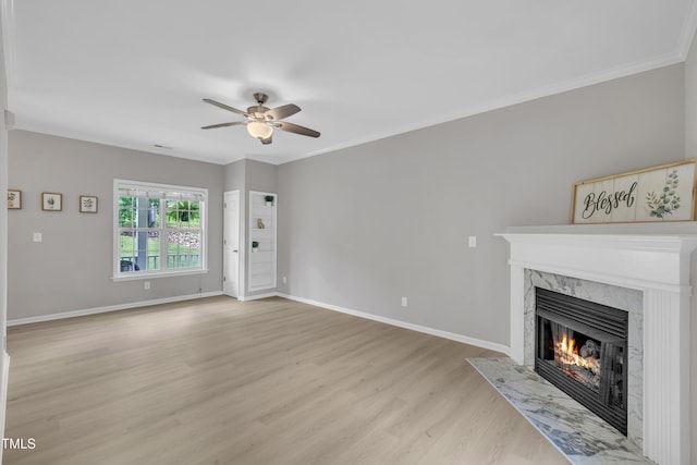 113 Feezor Ct, Clayton, NC 27527 - unfurnished living room featuring a high end fireplace, ceiling fan, light wood-style floors, and ornamental molding