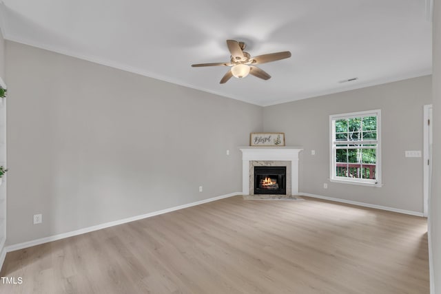 113 Feezor Ct, Clayton, NC 27527 - unfurnished living room featuring ceiling fan, light wood finished floors, a high end fireplace, and ornamental molding