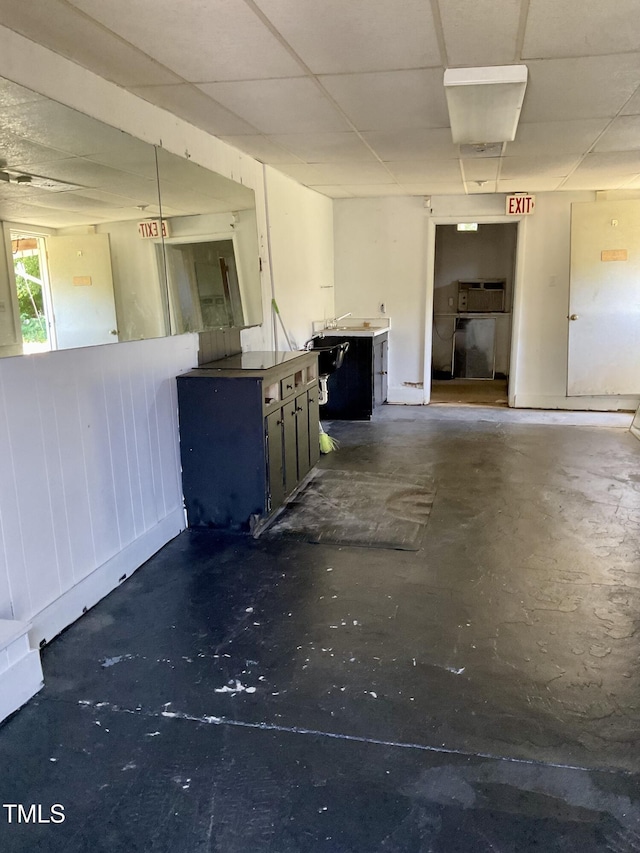 1403 S Roxboro St, Durham, NC 27703 - unfurnished living room with concrete flooring and a paneled ceiling