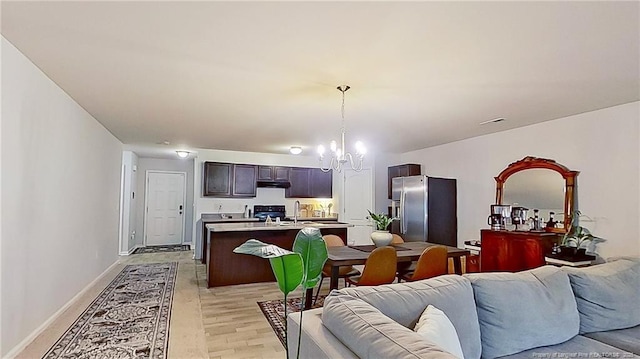 29 York Ct, Spring Lake, NC 28390 - living area with a chandelier, light wood finished floors, and baseboards