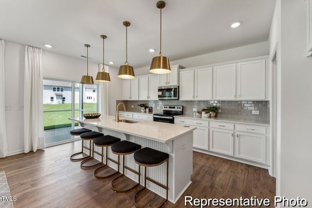 88 Mable Ct Unit 17, Lillington, NC 27546 - kitchen featuring stainless steel appliances, a sink, tasteful backsplash, white cabinets, and light countertops