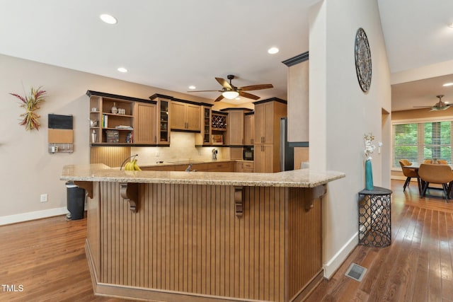 31 River View Ct, Timberlake, NC 27583 - kitchen featuring a ceiling fan, light stone countertops, baseboards, a kitchen breakfast bar, and recessed lighting
