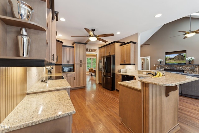 31 River View Ct, Timberlake, NC 27583 - kitchen with ceiling fan, black appliances, a peninsula, open floor plan, and light stone countertops