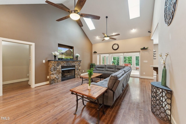 31 River View Ct, Timberlake, NC 27583 - living room with a skylight, high vaulted ceiling, ceiling fan, a fireplace, and baseboards