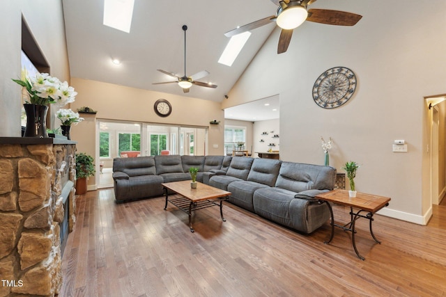 31 River View Ct, Timberlake, NC 27583 - living area featuring a skylight, a ceiling fan, high vaulted ceiling, light wood-style flooring, and baseboards