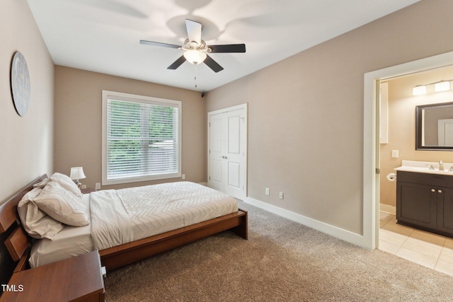 31 River View Ct, Timberlake, NC 27583 - bedroom featuring light colored carpet, baseboards, ensuite bathroom, a sink, and a ceiling fan