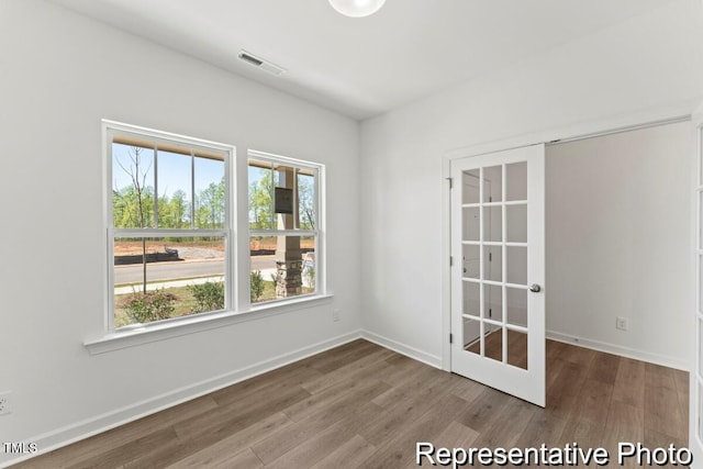 56 Mable Ct Unit 20, Lillington, NC 27546 - unfurnished room featuring wood finished floors, plenty of natural light, and baseboards