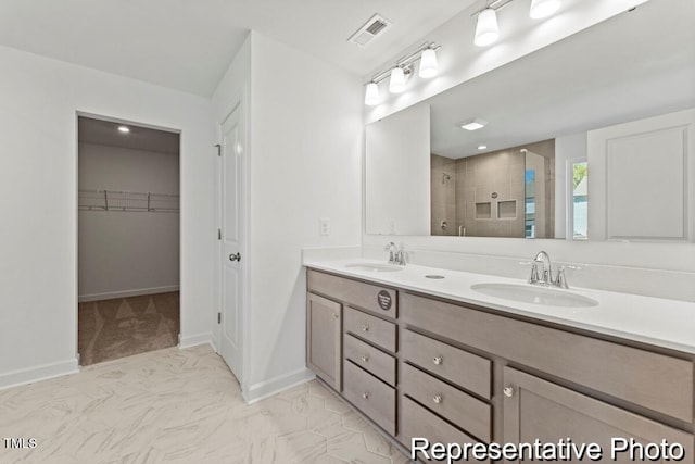 56 Mable Ct Unit 20, Lillington, NC 27546 - bathroom with a shower stall, double vanity, baseboards, marble finish floors, and a spacious closet