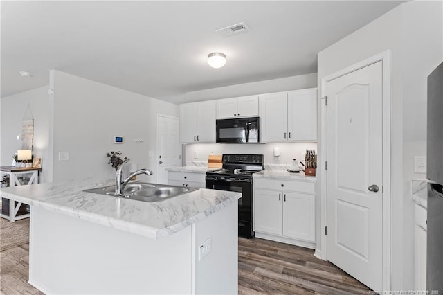 905 Sapphire Stone Ln, Hope Mills, NC 28348 - kitchen with black appliances, a sink, white cabinets, and dark wood-style flooring