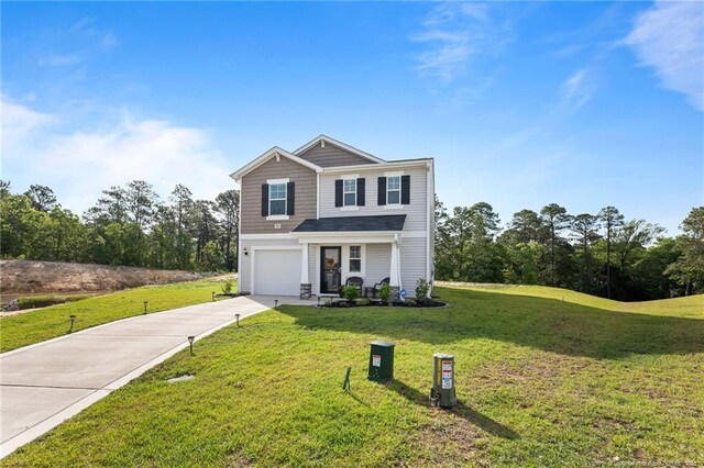 905 Sapphire Stone Ln, Hope Mills, NC 28348 - traditional home featuring concrete driveway, a front lawn, and a garage