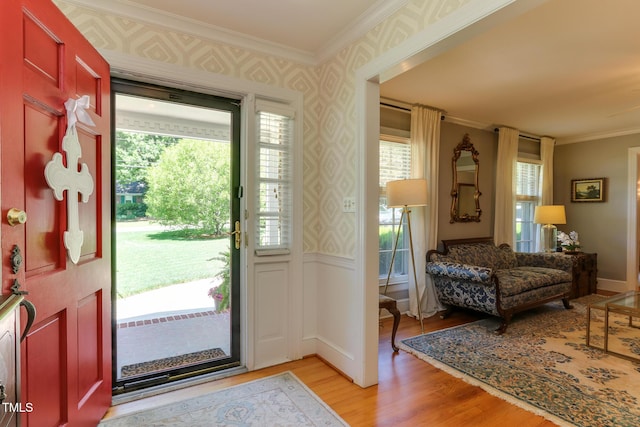 1206 Ivy Ln, Raleigh, NC 27609 - foyer featuring wallpapered walls, light wood-type flooring, and ornamental molding