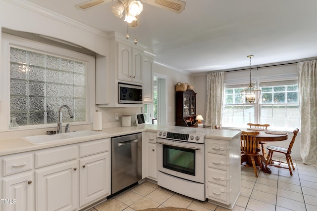 1206 Ivy Ln, Raleigh, NC 27609 - kitchen with stainless steel appliances, a sink, light tile patterned flooring, a peninsula, and white cabinets