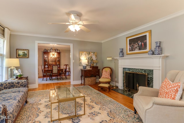 1206 Ivy Ln, Raleigh, NC 27609 - living area featuring wood finished floors, ornamental molding, ceiling fan, baseboards, and a fireplace