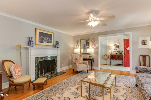 1206 Ivy Ln, Raleigh, NC 27609 - living area with crown molding, a ceiling fan, wood finished floors, a premium fireplace, and baseboards