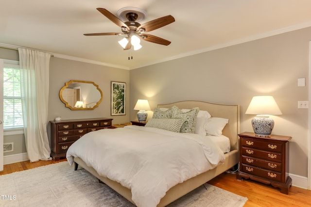 1206 Ivy Ln, Raleigh, NC 27609 - bedroom featuring wood finished floors, baseboards, ornamental molding, and ceiling fan