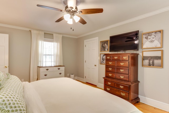 1206 Ivy Ln, Raleigh, NC 27609 - bedroom featuring crown molding, wood finished floors, baseboards, and ceiling fan