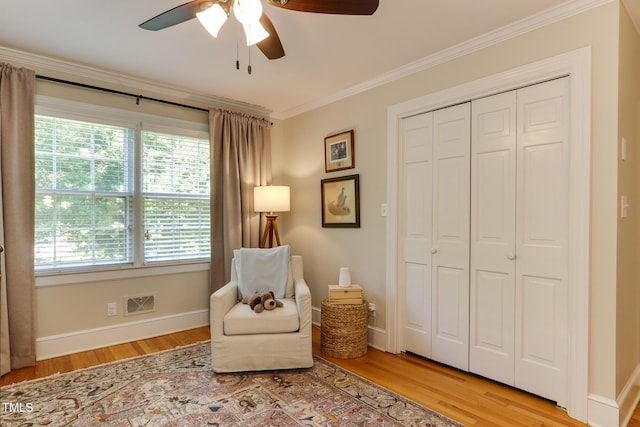1206 Ivy Ln, Raleigh, NC 27609 - living area with ceiling fan, ornamental molding, light wood-type flooring, plenty of natural light, and baseboards