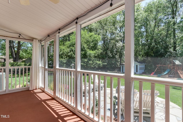 1206 Ivy Ln, Raleigh, NC 27609 - unfurnished sunroom with vaulted ceiling and view of scattered trees