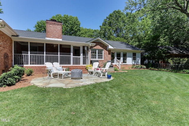 1206 Ivy Ln, Raleigh, NC 27609 - back of property featuring brick siding, a patio area, a sunroom, a chimney, and a shingled roof